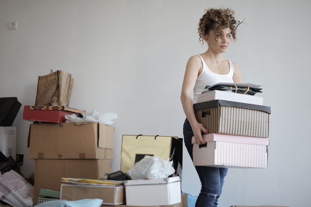 A woman organizes her belongings before moving.
