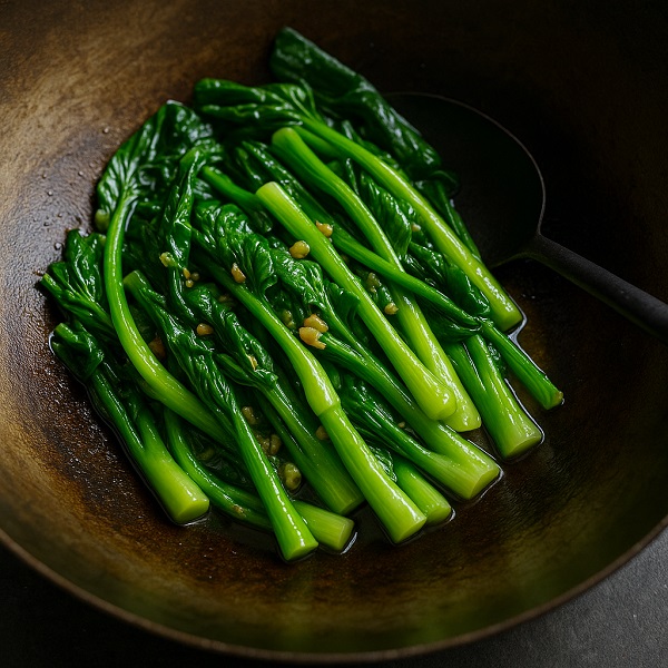 Choy sum stir-fried with garlic in a traditional Asian wok