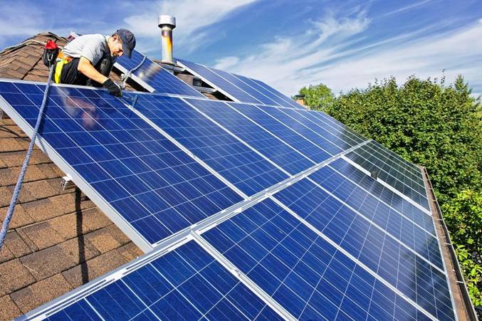 Installing solar panels on a rooftop
