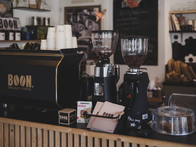 Niche Zero coffee grinder on sustainable café counter with beans and tools