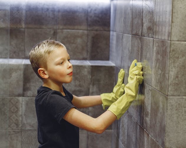 Kid trying to clean porcelain tile