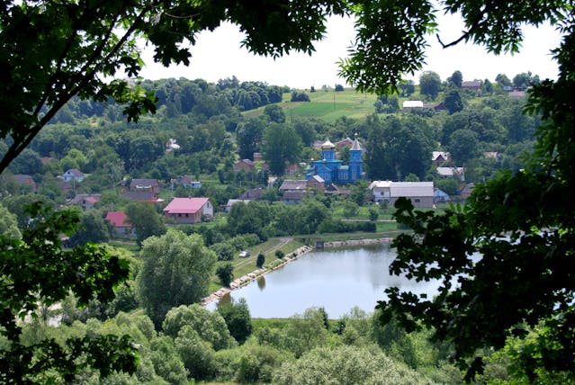 Peaceful Village Scene with Lake and Church
